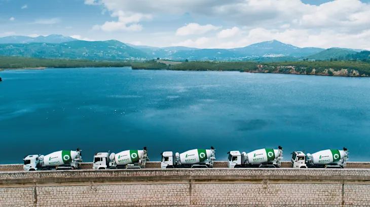 Holcim ECOPact trucks with water in background